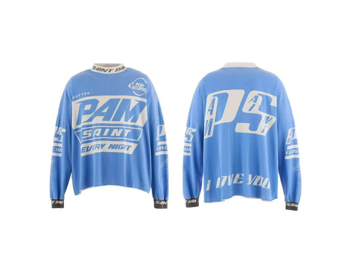 Front and back views of a light blue long-sleeve graphic shirt with white and dark blue lettering, including 'PAM SAINT EVERY NIGHT' on the front and 'PSY' on the back.